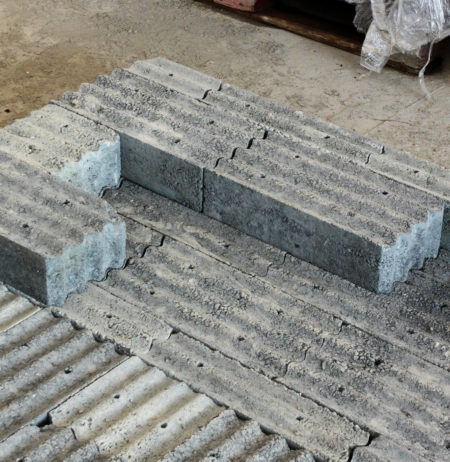 Several pieces of the concrete based lead-free material are disposed on the floor