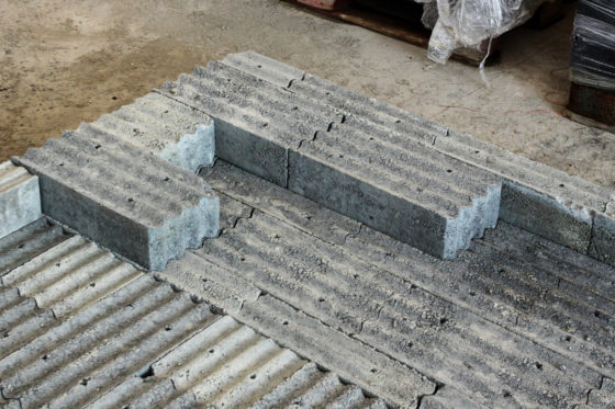 Several pieces of the concrete based lead-free material are disposed on the floor 